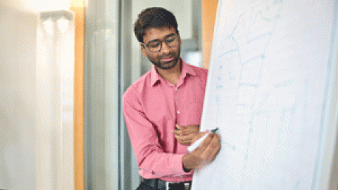 Person writing on a flipchart