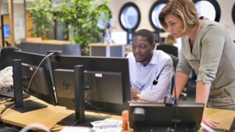 Two people looking at computer screens