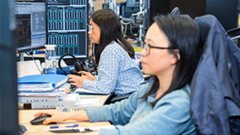 Banking traders sitting in front of terminals