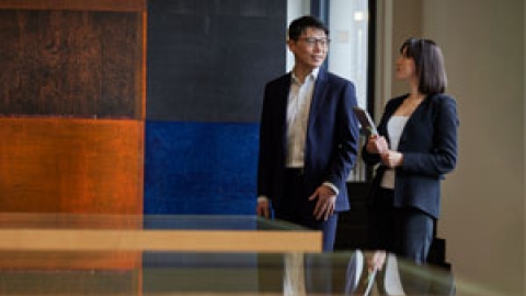 Two employees walking in the building and talking