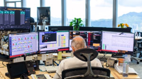 Trader in front of multiple screens