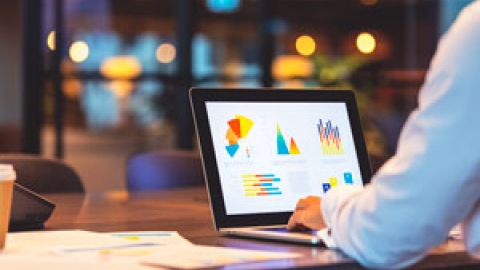 Person looking at a table displaying financial graphs