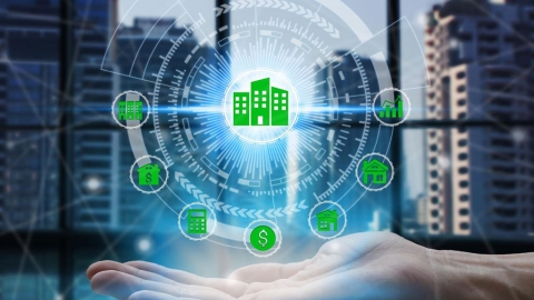 Building icons arranged in a circular pattern, held up by a hand with a city scape in the background