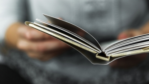 Person reading an open book