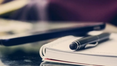 Pen and notebook on top of a table